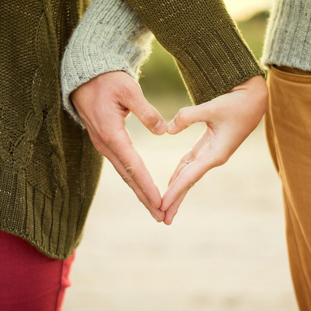 Couple makes heart shape with hands - marriage