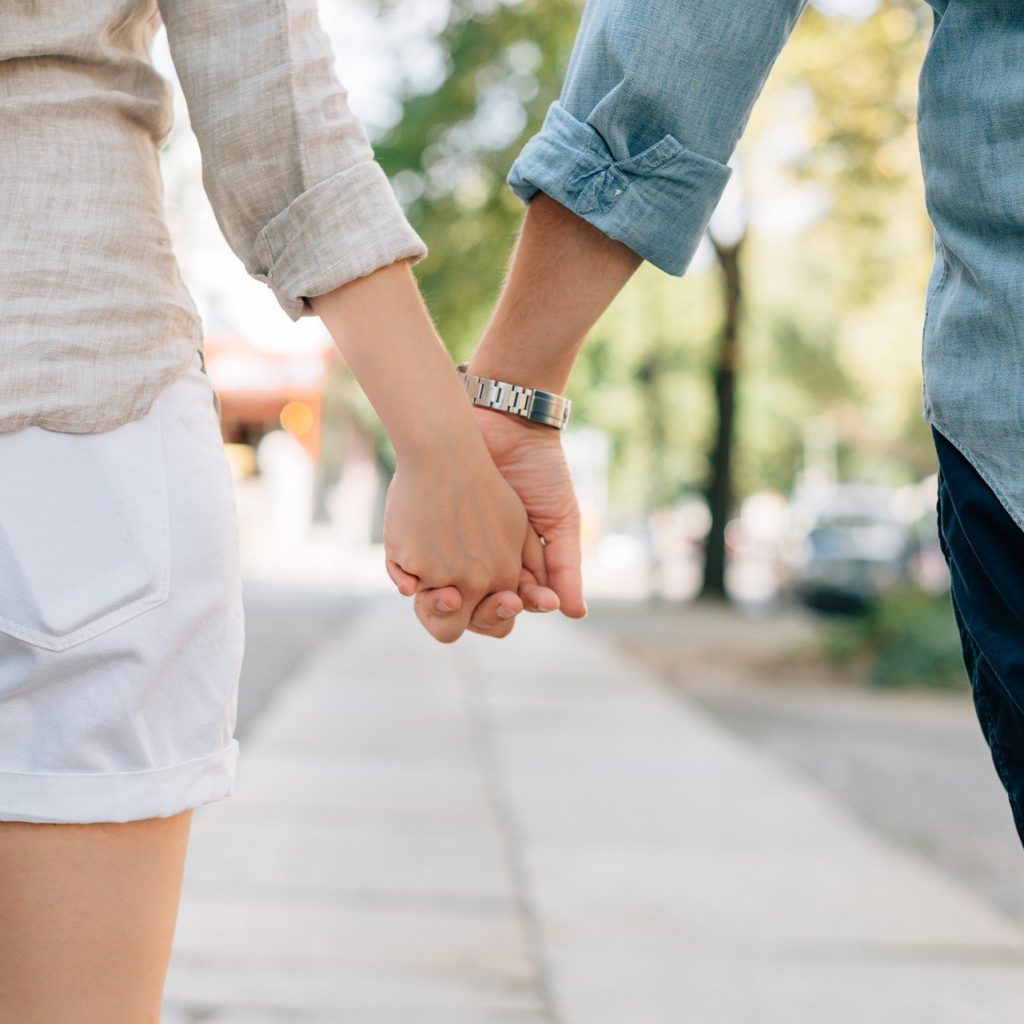 Loving couple holding hands - love