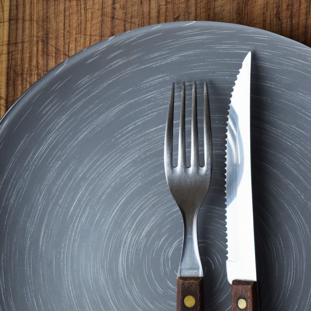 Knife and fork on an empty blue plate