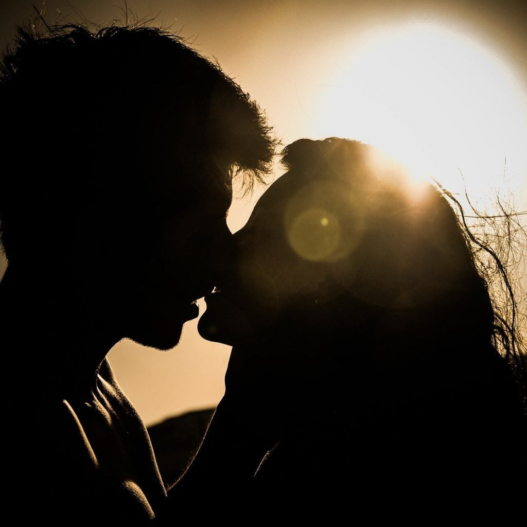 A couple kissing in sunset