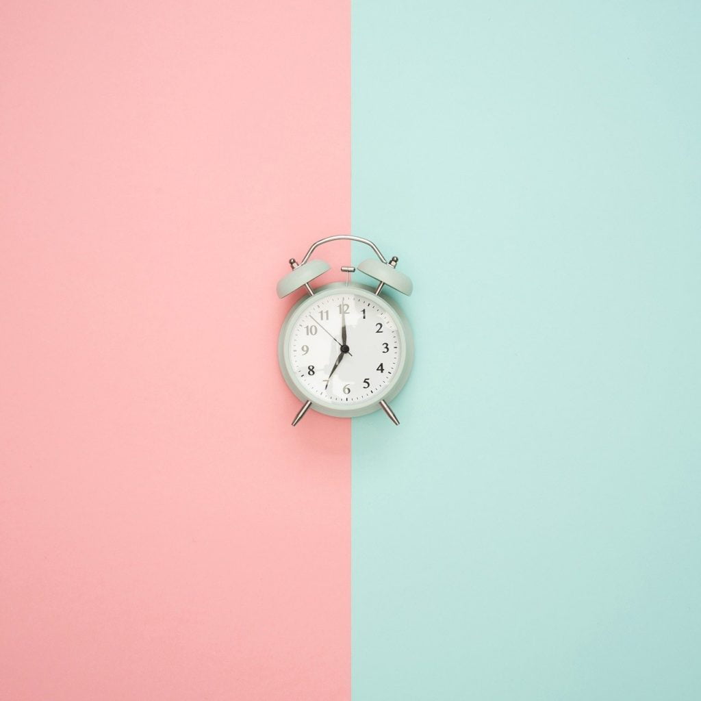 Small clock on green red background