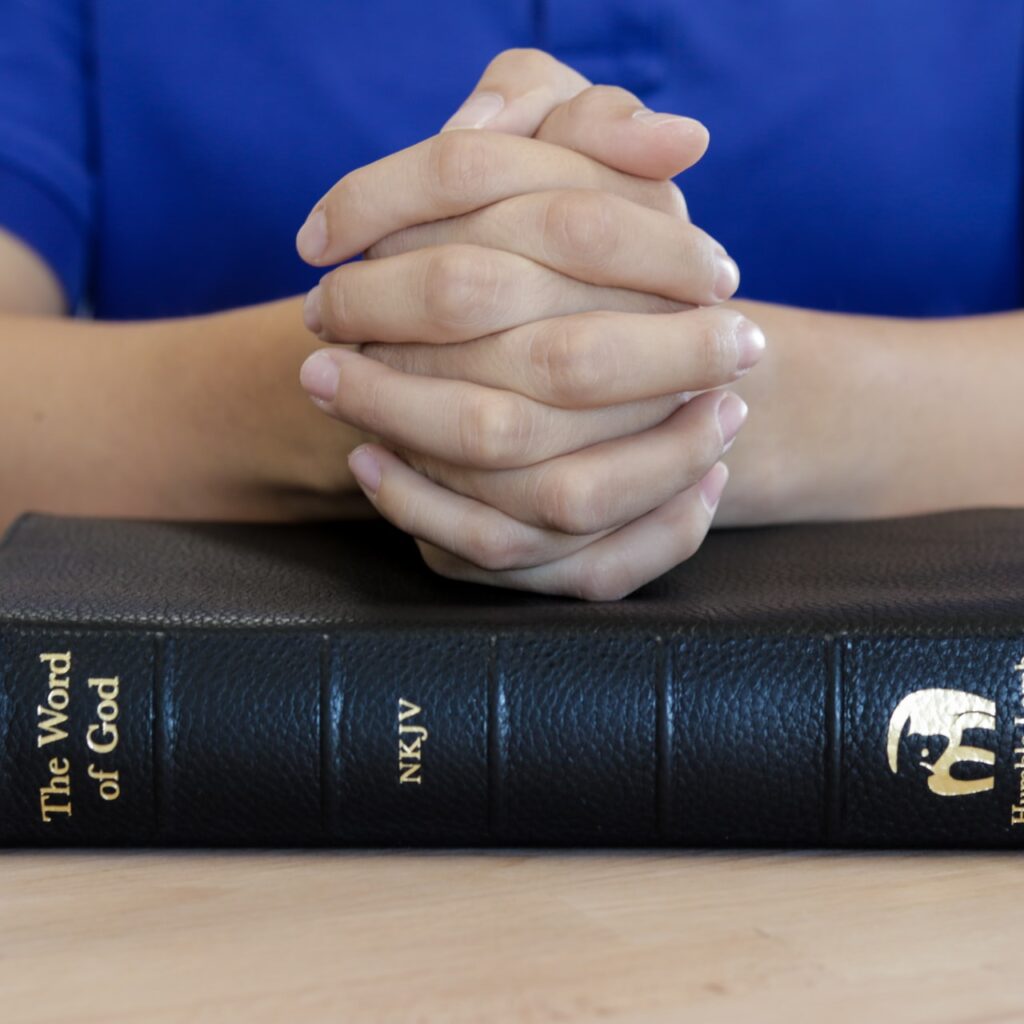 Man hand on KJV Bible