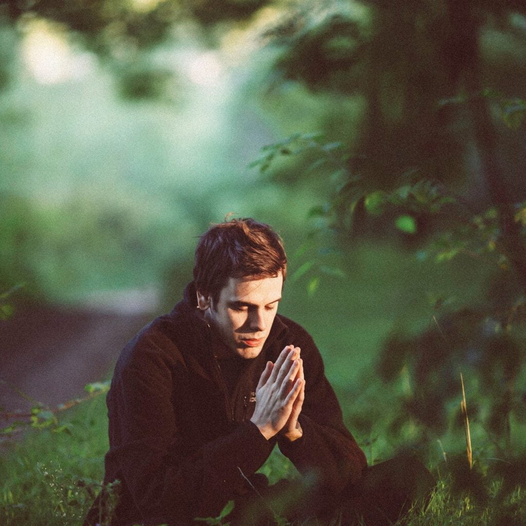 Man sitting and praying outside