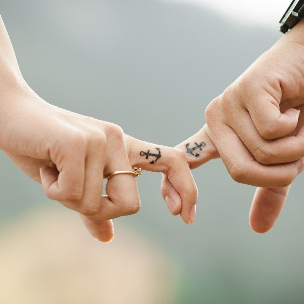 A couple's fingers tattoo with anchors - can we go to heaven with tattoos