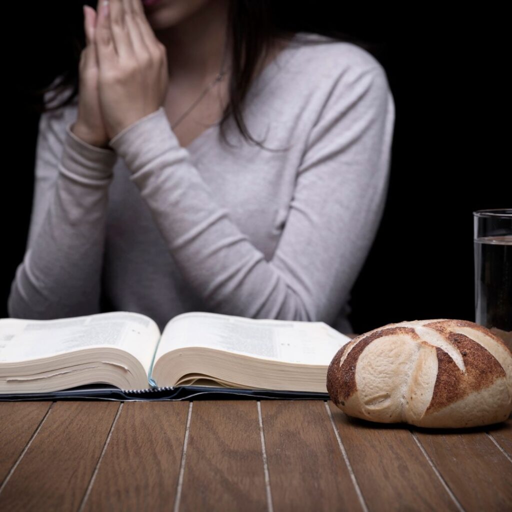 Woman Fasting and Praying With Bible Open
