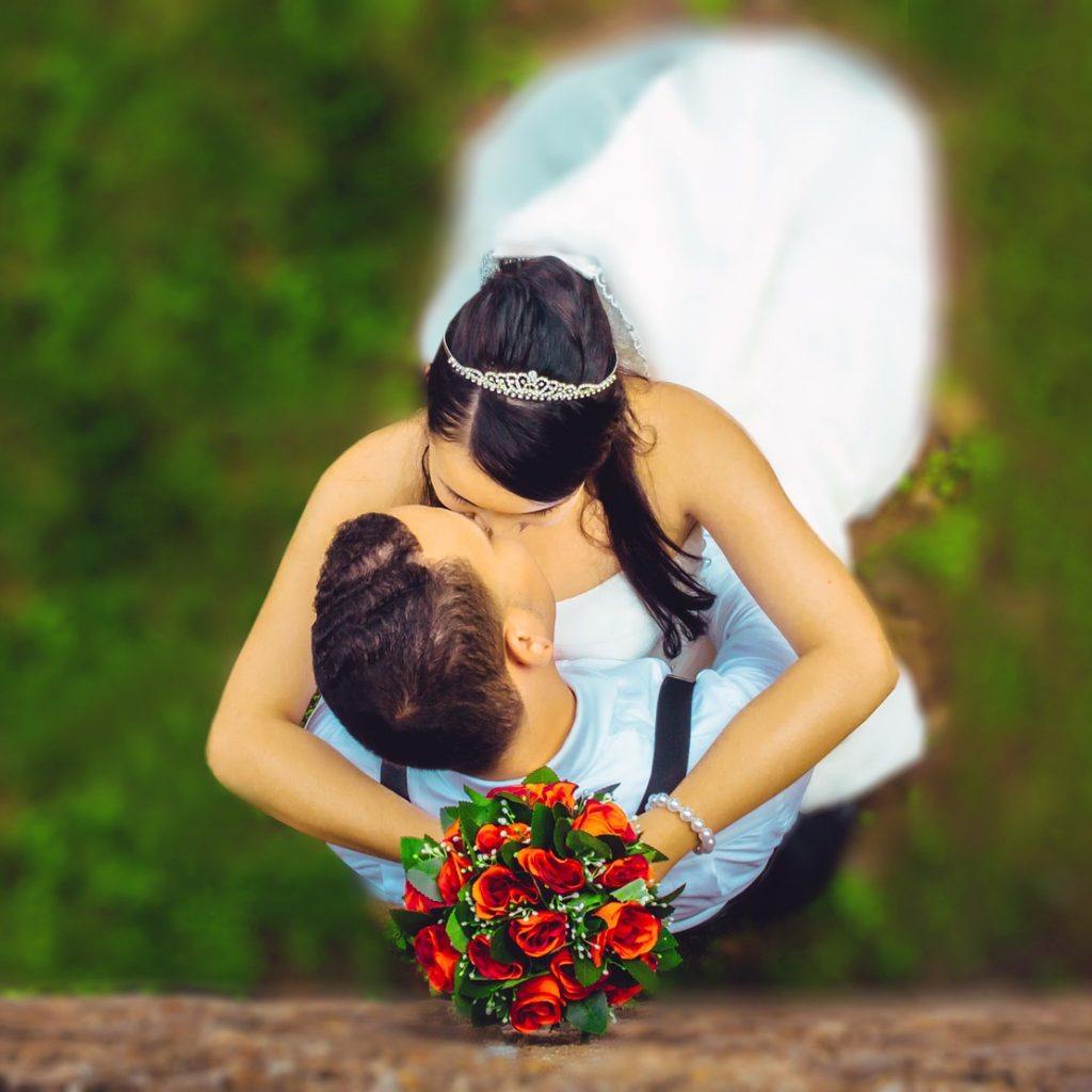 A married couple kissing