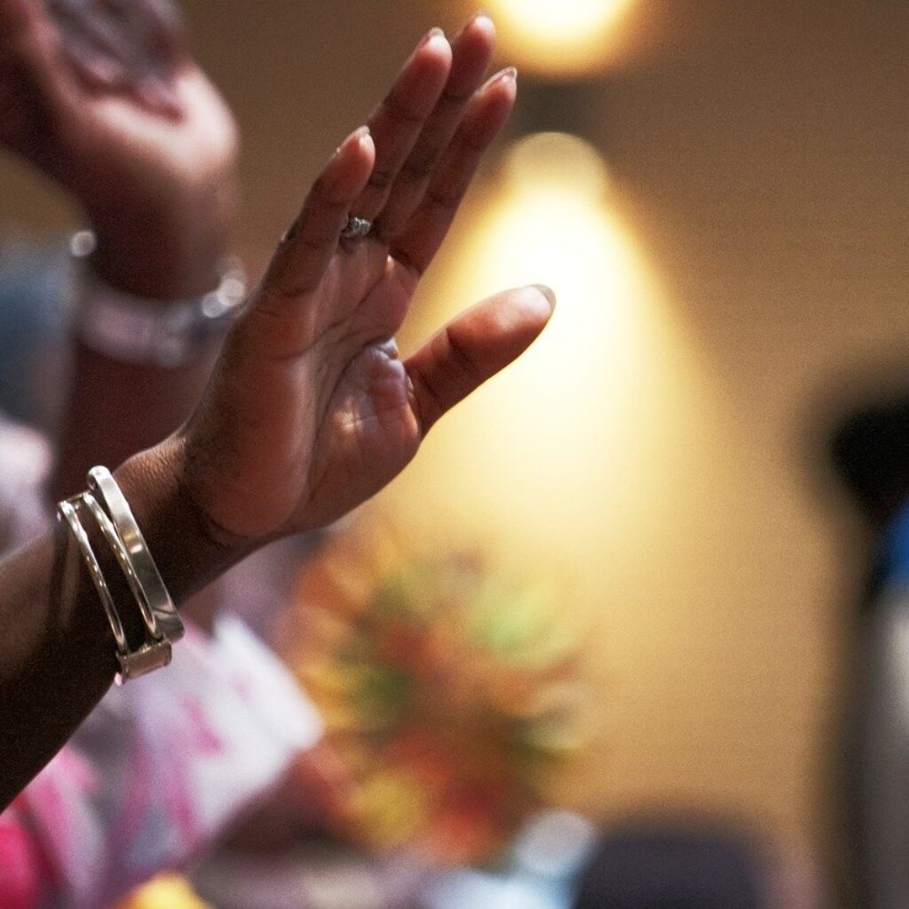 Woman raised hand. worshipping the LORD. Salvation
