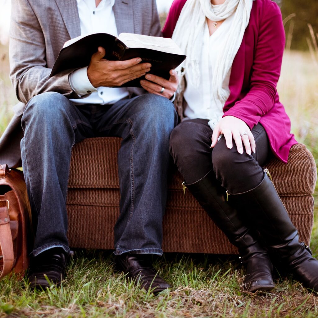 Couple sitting reading Bible