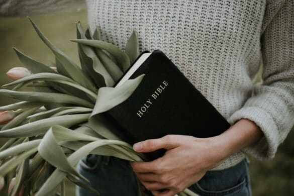 Girl holding Bible in hand-christianity facts