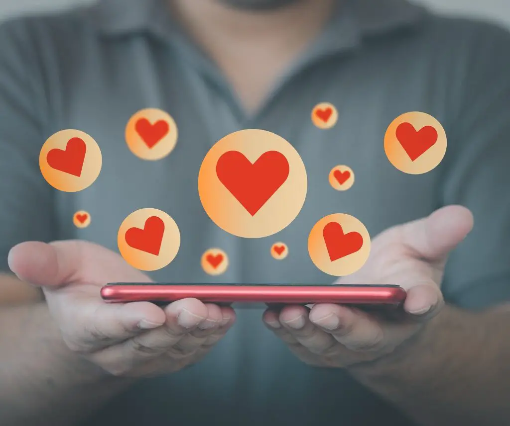 Man showing phone with hearts on it
