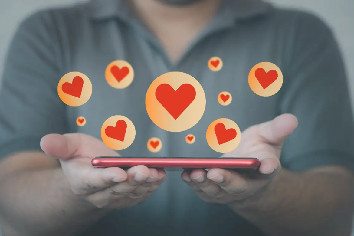 Man showing phone with hearts on it