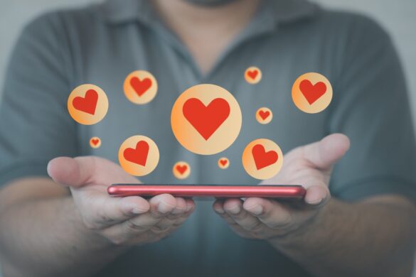 Man-showing-phone-with-hearts-on-it Man showing phone with hearts on it