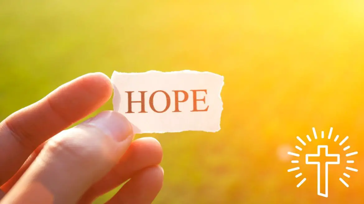 Person Holding The Word Hope Written On A Piece Of Paper