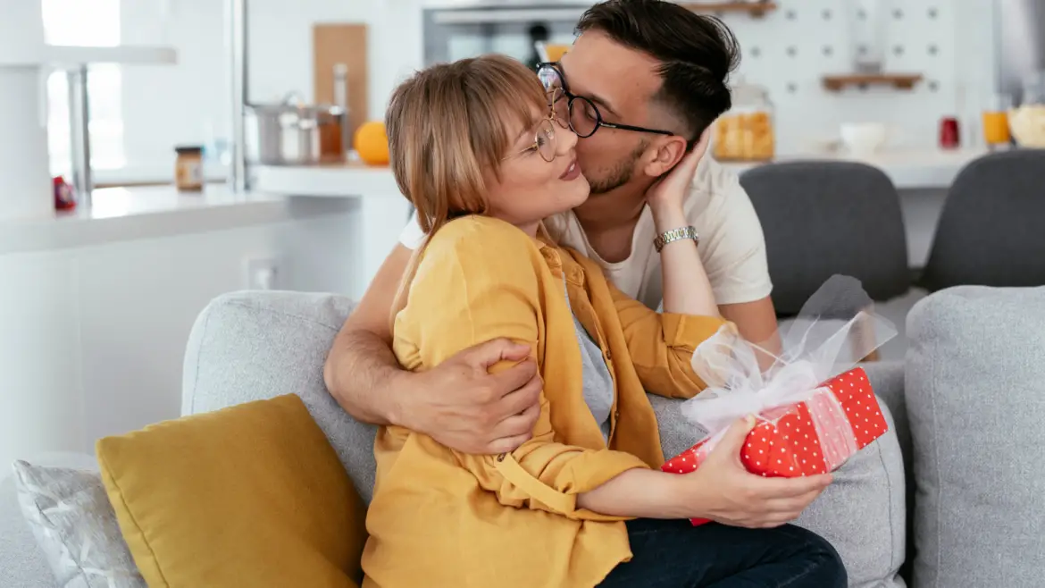 Christian Husband Kissing Wife and Giving Gift on Anniversary